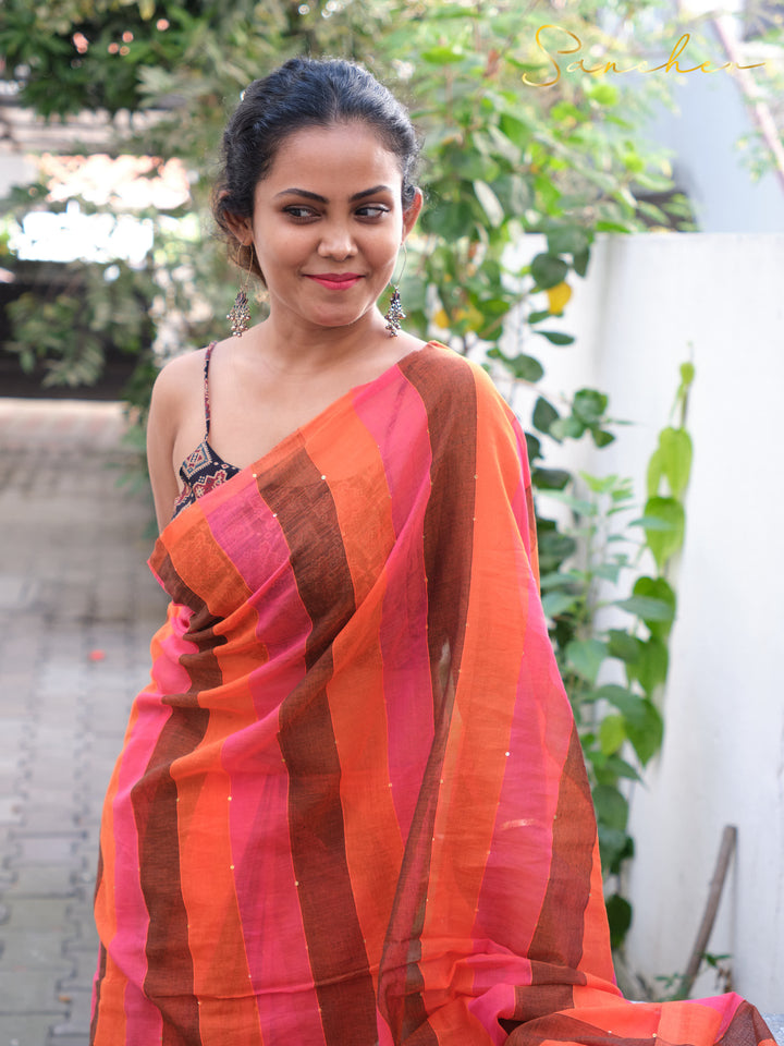 Close-up portrait of woman in colorful striped mul cotton saree, showcasing professional office wear sarees available online from Sancher boutique in Anna Nagar.