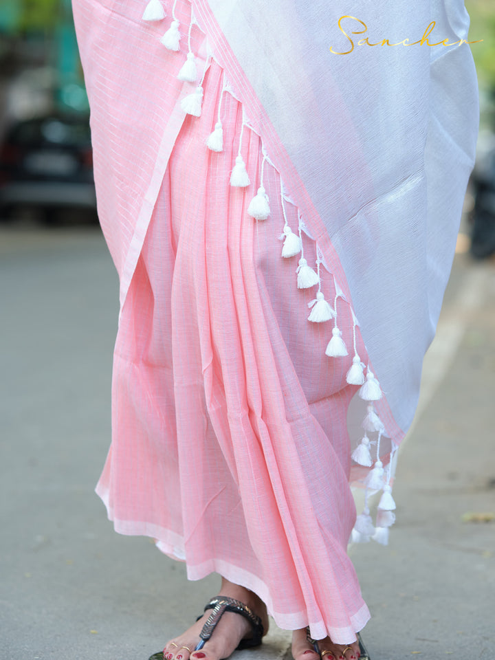 Close-up of pink mul cotton saree's pleats and white tassels, showcasing its lightweight and breathable fabric ideal for office wear. Keywords: Mul Cotton Sarees, Professional Office wear Sarees, Casual Sarees for Office Wear, Best Sarees Shops in Anna Nagar.