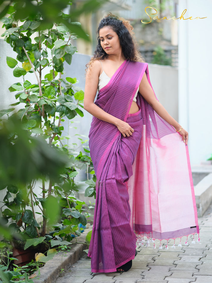 Woman modeling pink and purple striped mul cotton saree with tassels, showcasing workwear sarees from Sancher boutique.