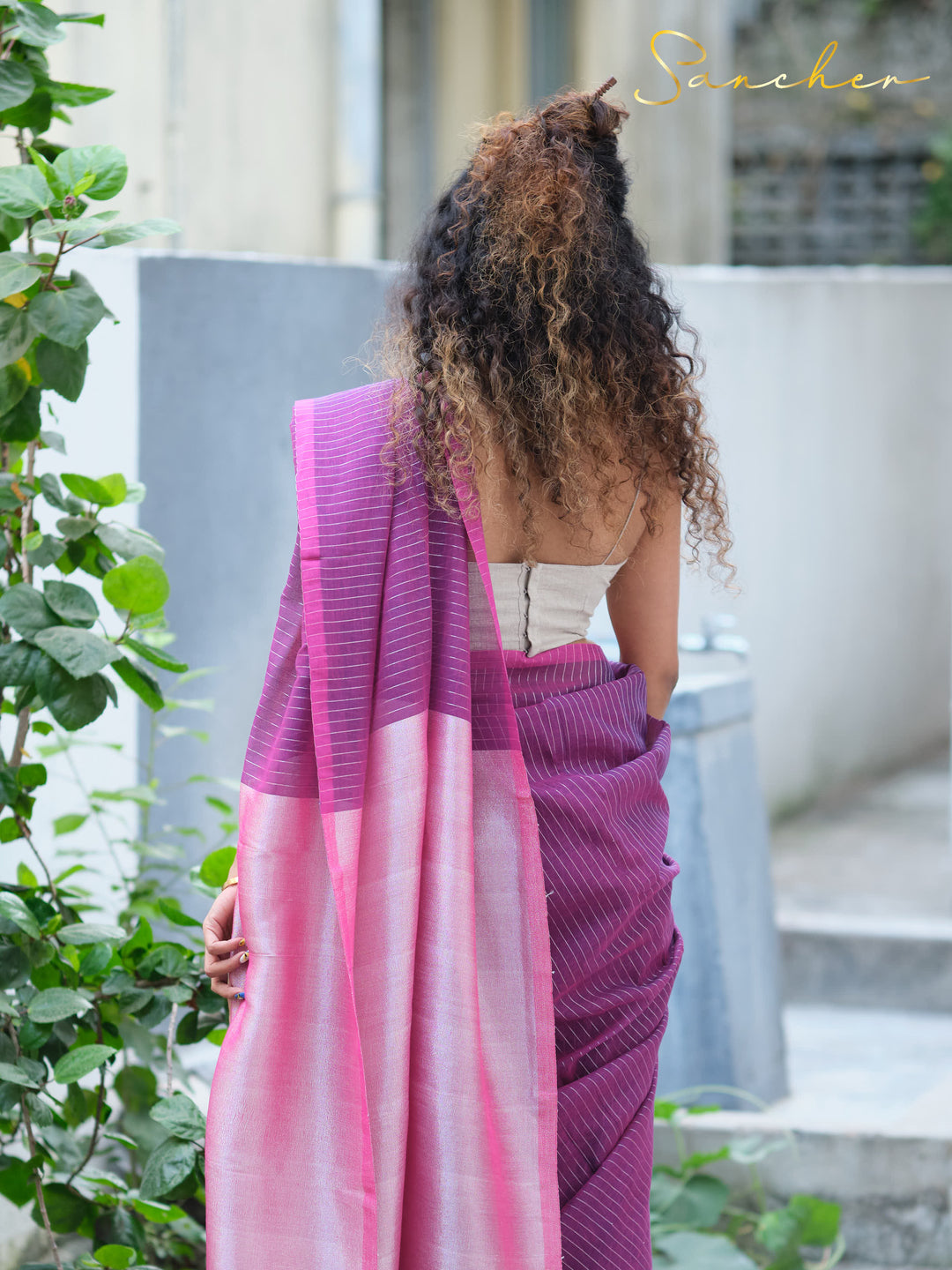 Back view of woman in purple striped mul cotton saree with pink pallu, displaying casual sarees for office wear from Anna Nagar saree shop.