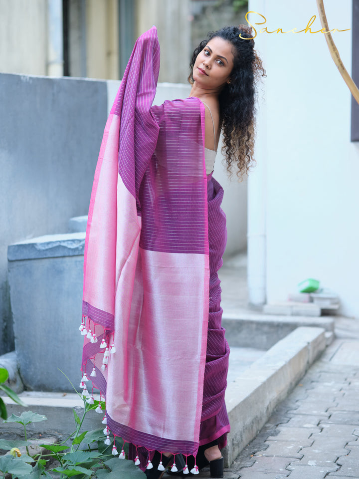 Woman modeling purple striped mul cotton saree with pink pallu and white tassels, representing professional office wear sarees from Sancher, a top saree shop in Anna Nagar.